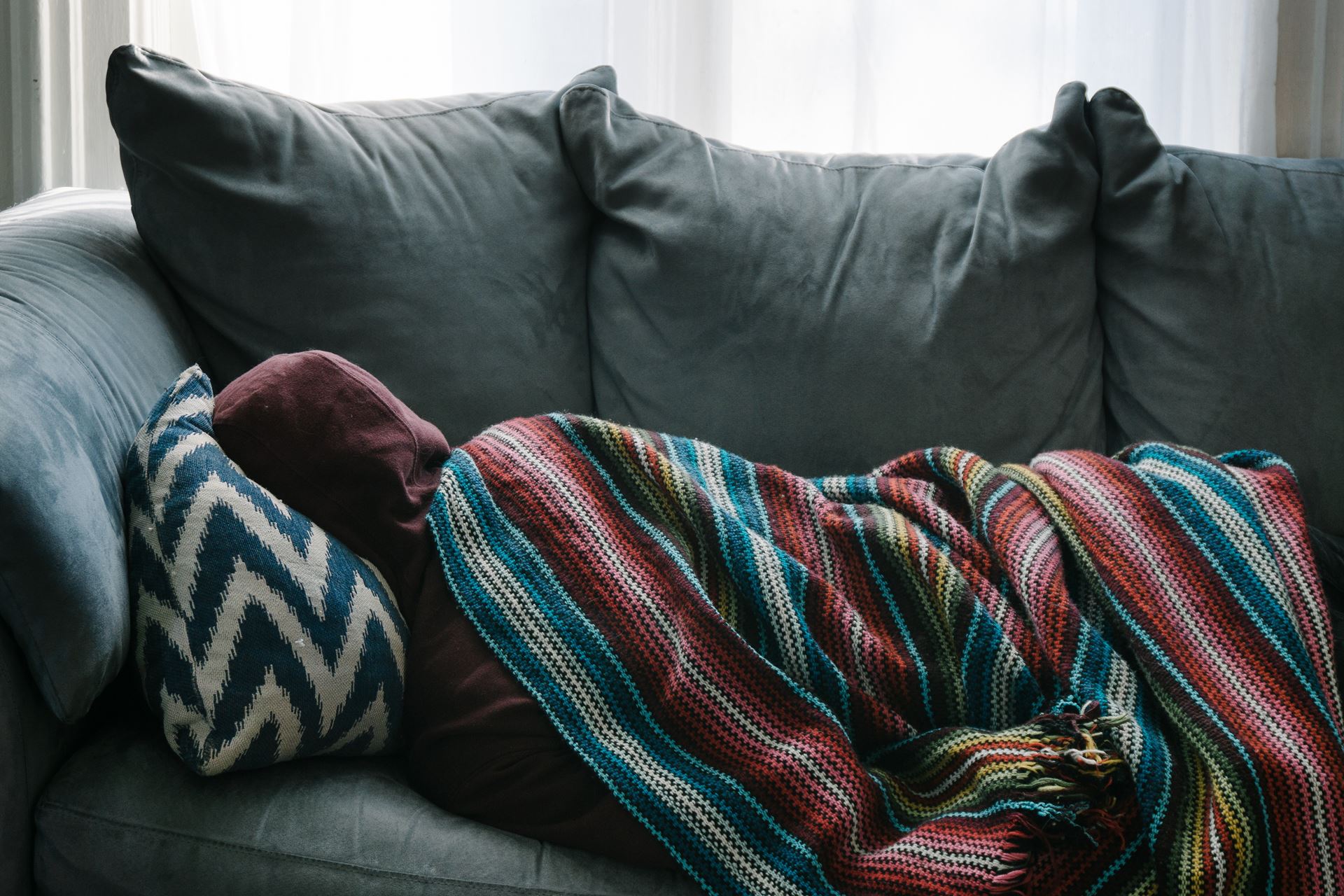 a person sleeping on a leather couch